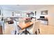 Dining room with wood table and chairs, open to living room at 1290 El Solindo Ln, Henderson, NV 89002