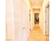 Bright hallway with tile flooring, leading to laundry and bedrooms at 1290 El Solindo Ln, Henderson, NV 89002