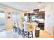 Kitchen with dark cabinets, granite counters, and island at 1290 El Solindo Ln, Henderson, NV 89002