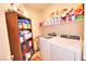 Laundry room with washer, dryer, and shelving at 1290 El Solindo Ln, Henderson, NV 89002