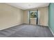 Spacious bedroom with gray carpet and a view at 1306 Big Tree Ave, North Las Vegas, NV 89031