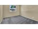 Bright bedroom with carpet flooring and a window with garden view at 1306 Big Tree Ave, North Las Vegas, NV 89031