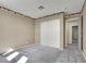 Simple bedroom with carpet, double door closet and palm tree border at 1306 Big Tree Ave, North Las Vegas, NV 89031