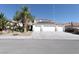 Two-story house with three-car garage, solar panels, and desert landscaping at 1306 Big Tree Ave, North Las Vegas, NV 89031