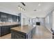 Modern kitchen with dark cabinets, large island, and stainless steel appliances at 1306 Big Tree Ave, North Las Vegas, NV 89031