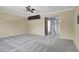 Main bedroom with ceiling fan, carpet flooring and access to upper hallway at 1306 Big Tree Ave, North Las Vegas, NV 89031