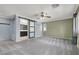 Main bedroom with barn door leading to en-suite bathroom and ceiling fan at 1306 Big Tree Ave, North Las Vegas, NV 89031