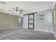 Main bedroom with two-toned walls, ceiling fan and barn door at 1306 Big Tree Ave, North Las Vegas, NV 89031