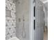 Modern shower with geometric patterned tile walls at 1306 Big Tree Ave, North Las Vegas, NV 89031