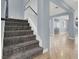 Modern staircase with gray carpeting and white railing at 1306 Big Tree Ave, North Las Vegas, NV 89031