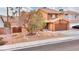 Two-story house with a tree in front and a landscaped yard at 1411 Bareback Ct, Henderson, NV 89014