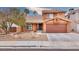 Two-story house with brown garage door and landscaped front yard at 1411 Bareback Ct, Henderson, NV 89014