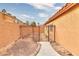 Side yard with a gate and small landscaped area at 1411 Bareback Ct, Henderson, NV 89014