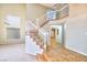 Elegant staircase with white railing and tiled flooring at 1411 Bareback Ct, Henderson, NV 89014