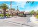 Gated community entrance with palm trees and landscaping at 1751 E Reno Ave # 206, Las Vegas, NV 89119