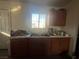 Small kitchen with double sink and wood cabinets at 1900 W Carey Ave, North Las Vegas, NV 89032