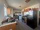 A galley kitchen with wood cabinets and appliances at 1900 W Carey Ave, North Las Vegas, NV 89032
