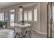 Bright breakfast nook with white table and chairs, near a back door at 2020 Hallston St, Las Vegas, NV 89134