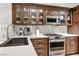 Modern kitchen with dark wood cabinets and quartz countertops at 220 E Flamingo Rd # 426, Las Vegas, NV 89169
