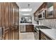 Modern kitchen with dark wood cabinets and stainless steel appliances at 220 E Flamingo Rd # 426, Las Vegas, NV 89169