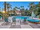 Relaxing pool area with turquoise lounge chairs and palm trees at 220 E Flamingo Rd # 426, Las Vegas, NV 89169