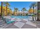 Sparkling community pool with lounge chairs and palm trees at 220 E Flamingo Rd # 426, Las Vegas, NV 89169