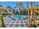 Inviting community pool with teal lounge chairs and checkerboard patio at 220 E Flamingo Rd # 426, Las Vegas, NV 89169