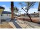 Backyard view of multiple residential units with desert landscaping, mature trees, and privacy fencing at 240 S 16Th St, Las Vegas, NV 89101