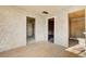 Bedroom featuring textured walls and hardwood flooring, leading to additional rooms and a bathroom at 240 S 16Th St, Las Vegas, NV 89101