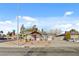 Street view of a single-story home with xeriscaped front yard, palm trees, and covered porch at 240 S 16Th St, Las Vegas, NV 89101