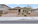 Single story home with two car garage and landscaping at 2432 Mesa Wind Ave, North Las Vegas, NV 89030