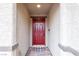 Red front door with a welcome mat at 2432 Mesa Wind Ave, North Las Vegas, NV 89030