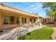 Spacious backyard with patio, seating area, and putting green at 2563 Collinsville Dr, Henderson, NV 89052