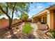 Landscaped backyard with a stone pathway and lush greenery at 2563 Collinsville Dr, Henderson, NV 89052