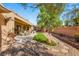 Landscaped backyard with a stone pathway and lush greenery at 2563 Collinsville Dr, Henderson, NV 89052
