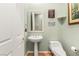 Clean bathroom with pedestal sink and toilet at 2563 Collinsville Dr, Henderson, NV 89052