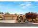 Single-story house with three-car garage,landscaped front yard, and neutral color scheme at 2563 Collinsville Dr, Henderson, NV 89052