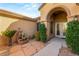 Inviting entryway with double doors, stone pathway, and lush landscaping at 2563 Collinsville Dr, Henderson, NV 89052