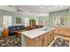 Open-concept kitchen with a large island, light-colored cabinetry, and gas cooktop at 2563 Collinsville Dr, Henderson, NV 89052