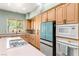 Bright kitchen featuring light wood cabinets and teal appliances at 2563 Collinsville Dr, Henderson, NV 89052