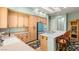 Spacious kitchen with light wood cabinets, island, and teal refrigerator at 2563 Collinsville Dr, Henderson, NV 89052
