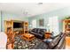 Relaxing living room with leather furniture, a floral rug, and built-in shelving at 2563 Collinsville Dr, Henderson, NV 89052