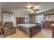 Bright bedroom with a double bed, dresser, and comfortable armchair at 2671 Colina Bella Ct, Las Vegas, NV 89142