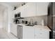 Modern kitchen with white cabinets, stainless steel appliances, and a microwave at 29 Montelago Blvd # 337, Henderson, NV 89011