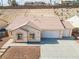 Single-story house with a two-car garage and landscaped yard at 2915 Rippling Springs St, Laughlin, NV 89029