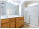 Double vanity bathroom with a large shower and wood cabinets at 2915 Rippling Springs St, Laughlin, NV 89029