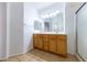 Double sink bathroom with wood cabinets and a shower at 2915 Rippling Springs St, Laughlin, NV 89029