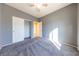 Well-lit bedroom featuring grey walls, carpet, and a double door closet at 2915 Rippling Springs St, Laughlin, NV 89029