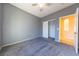Bright bedroom with grey walls, carpet, and spacious closet at 2915 Rippling Springs St, Laughlin, NV 89029