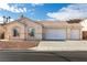 Single-story house with a two-car garage and desert landscaping at 2915 Rippling Springs St, Laughlin, NV 89029
